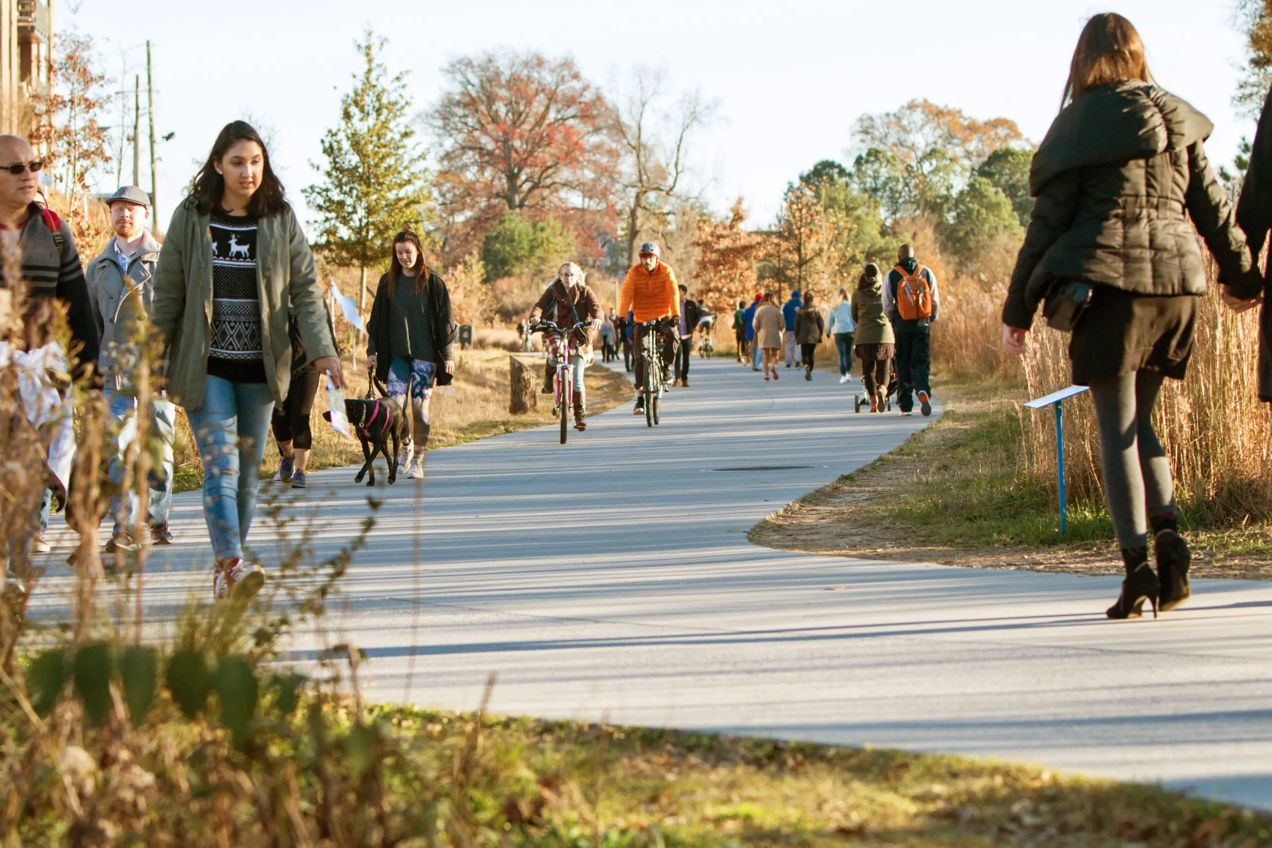 People walk, run, and bike along the Atlanta Beltline recreational area in the Old Fourth Ward in Atlanta, GA.