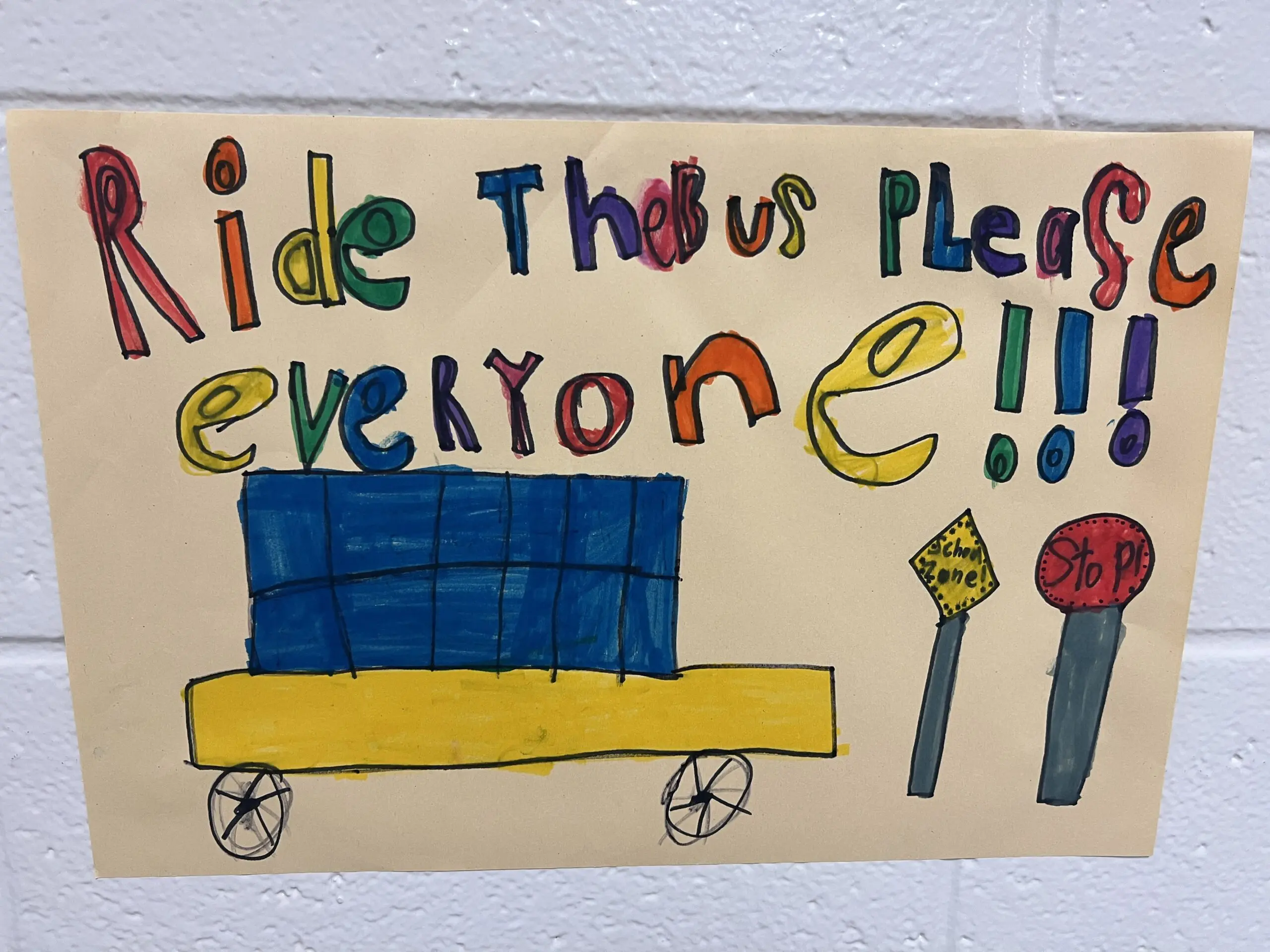 Image of a children's poster saying "Ride the bus pleas everyone."