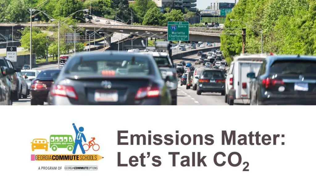 1 Cars in heavy traffic on a highway with green trees on both sides. A sign reads "Emissions Matter: Let's Talk CO₂" with the Georgia Commute Schools logo at the bottom.