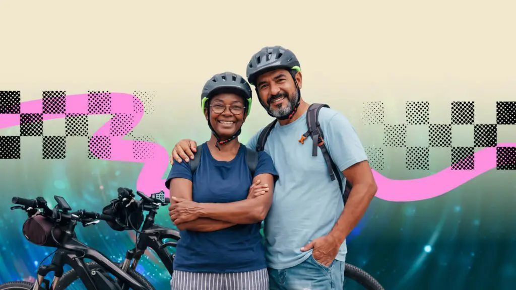 Two adults wearing helmets stand close together, smiling beside bicycles. The background is a digital mix of abstract patterns with pink and black shapes on a light and blue gradient backdrop.