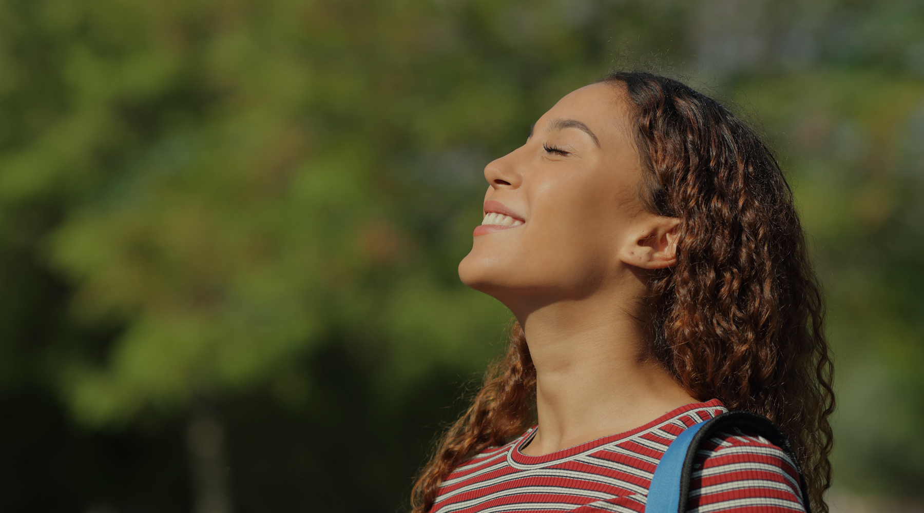 Image of person smiling at the sky,