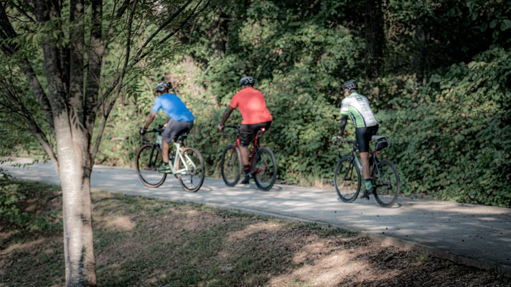 Three bikers riding on a trail together.