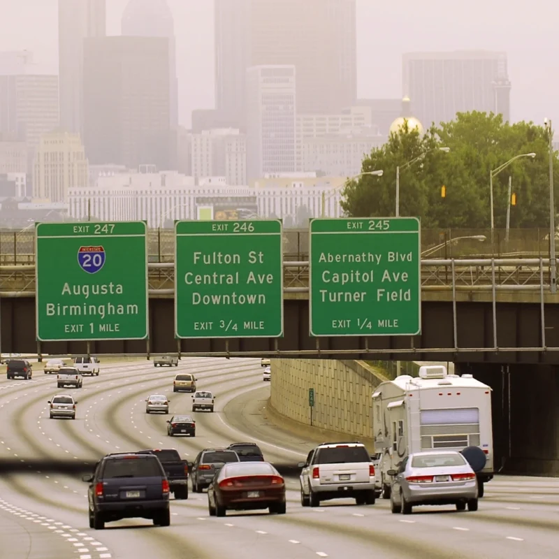 Photo of an Atlanta freeway, there are several cars going down the freeway.