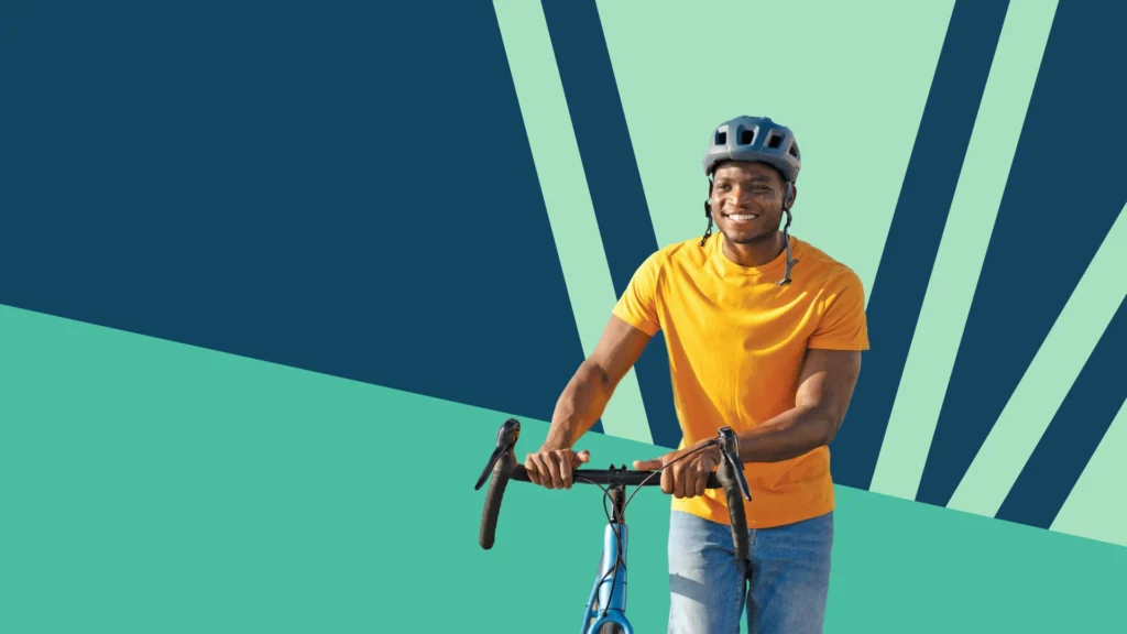 man walking his bike with decorative background