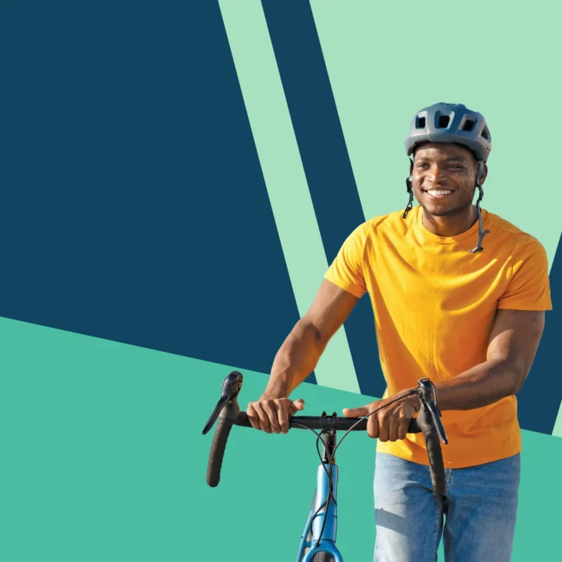 man walking his bike with decorative background