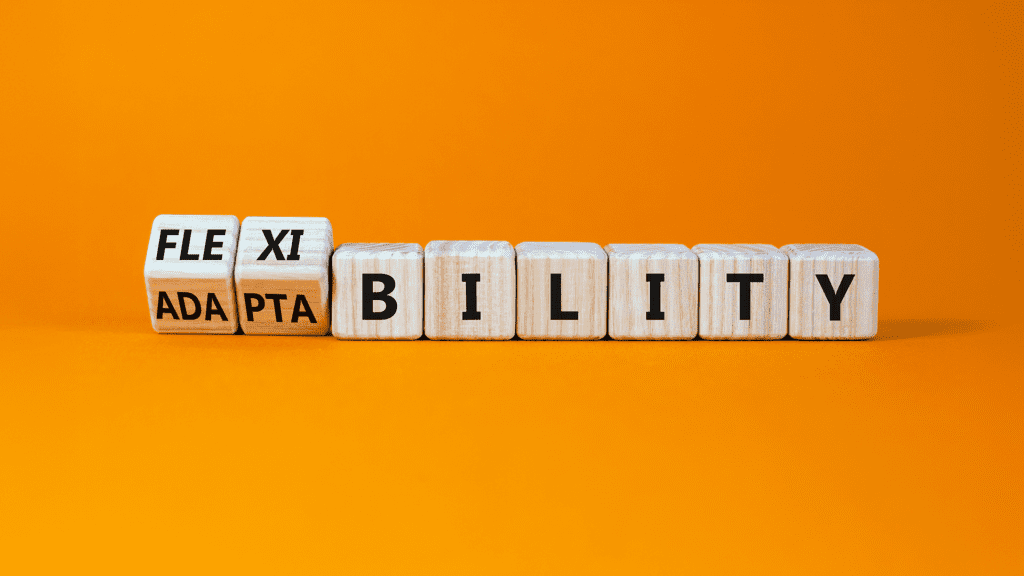 Wooden game tiles spell out the words “flexibility” and “adaptability".