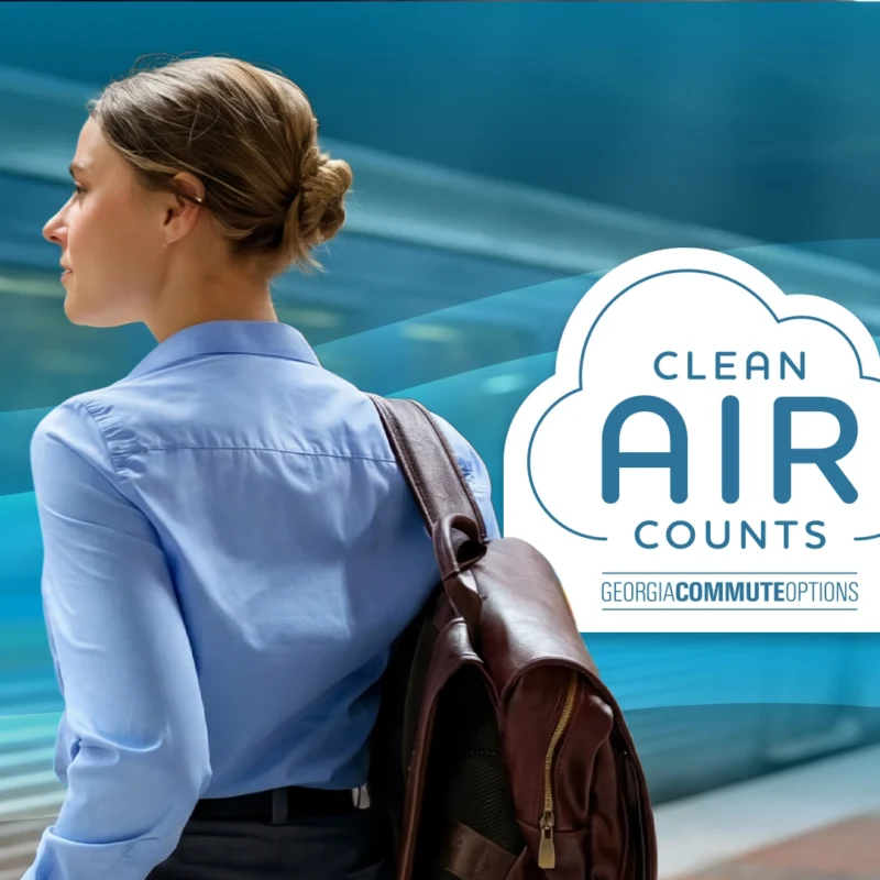 A woman with a backpack waits on a train platform. Next to her is a cloud-shaped graphic with the text "Clean Air Counts" and "Georgia Commute Options." A train is blurred in the background.